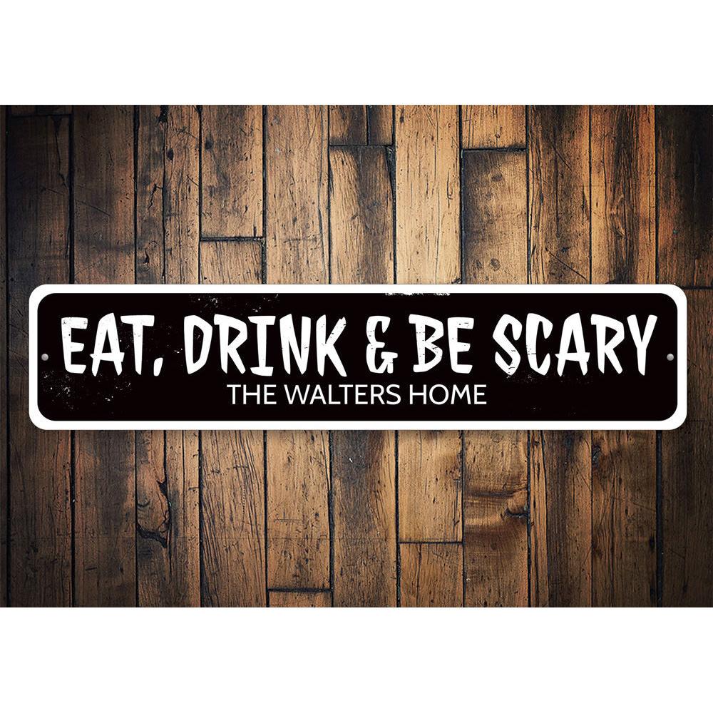 A decorative 'Eat Drink and Be Scary' sign made of aluminum, featuring spooky Halloween-themed text, perfect for home decor.