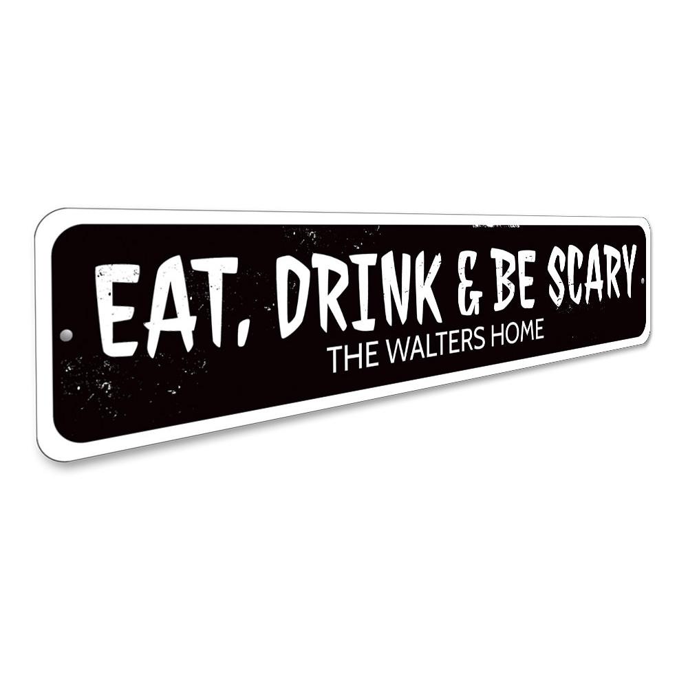 A decorative 'Eat Drink and Be Scary' sign made of aluminum, featuring spooky Halloween-themed text, perfect for home decor.