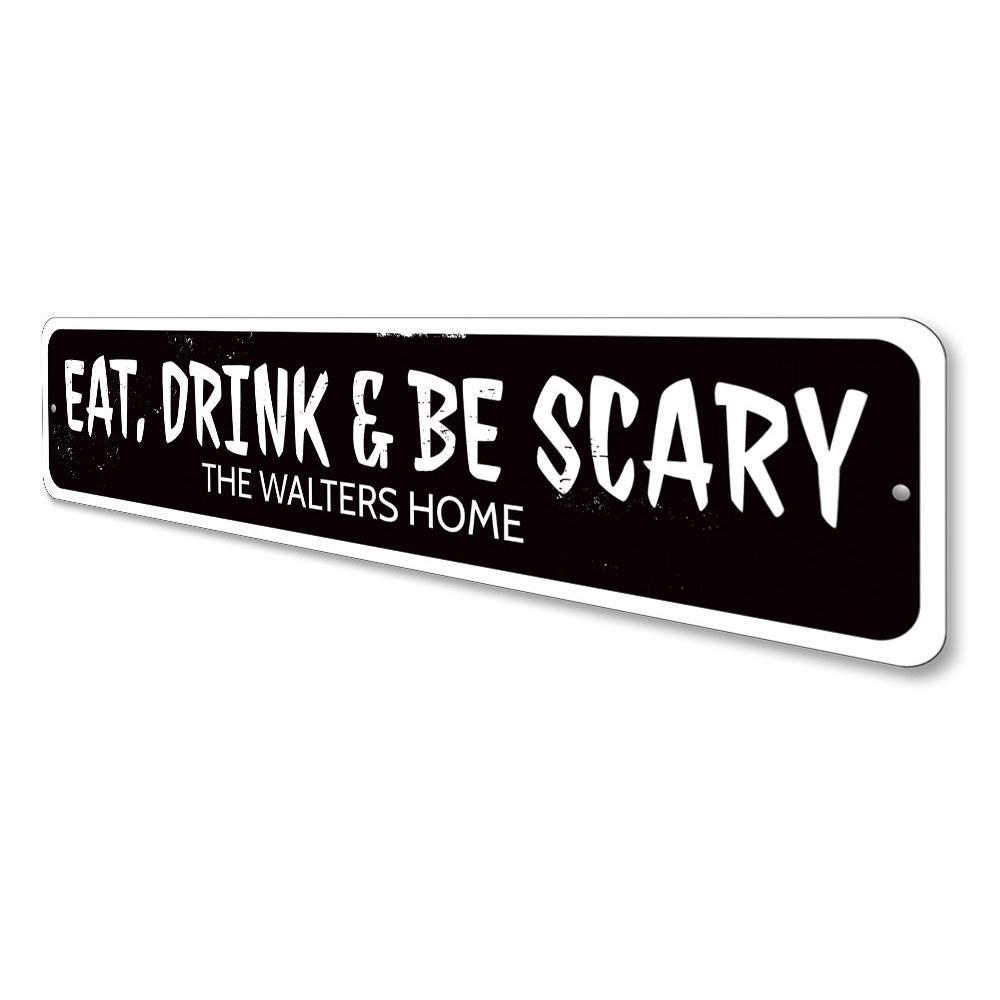 A decorative 'Eat Drink and Be Scary' sign made of aluminum, featuring spooky Halloween-themed text, perfect for home decor.