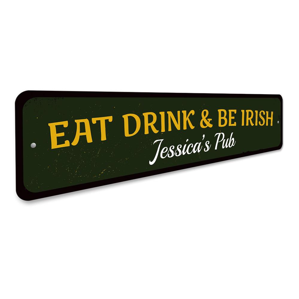 A decorative 'Eat Drink & Be Irish' metal sign, featuring vibrant colors and a charming design, perfect for home decor.