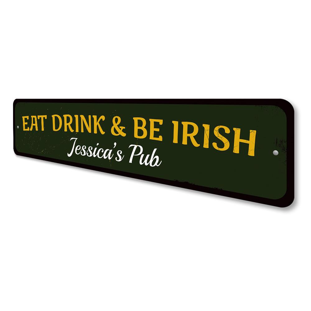 A decorative 'Eat Drink & Be Irish' metal sign, featuring vibrant colors and a charming design, perfect for home decor.