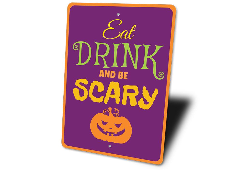 A decorative metal sign featuring the phrase 'Eat Drink Be Scary' designed for Halloween decor, showcasing spooky elements.