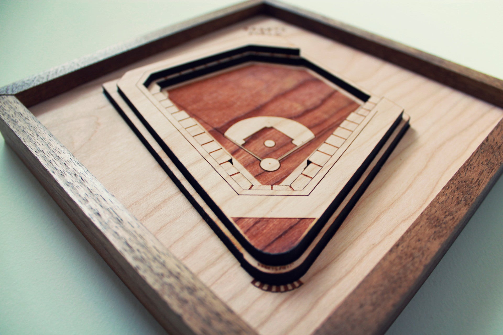 Ebbets Field replica showcasing intricate details and premium hardwood craftsmanship, framed in black walnut.