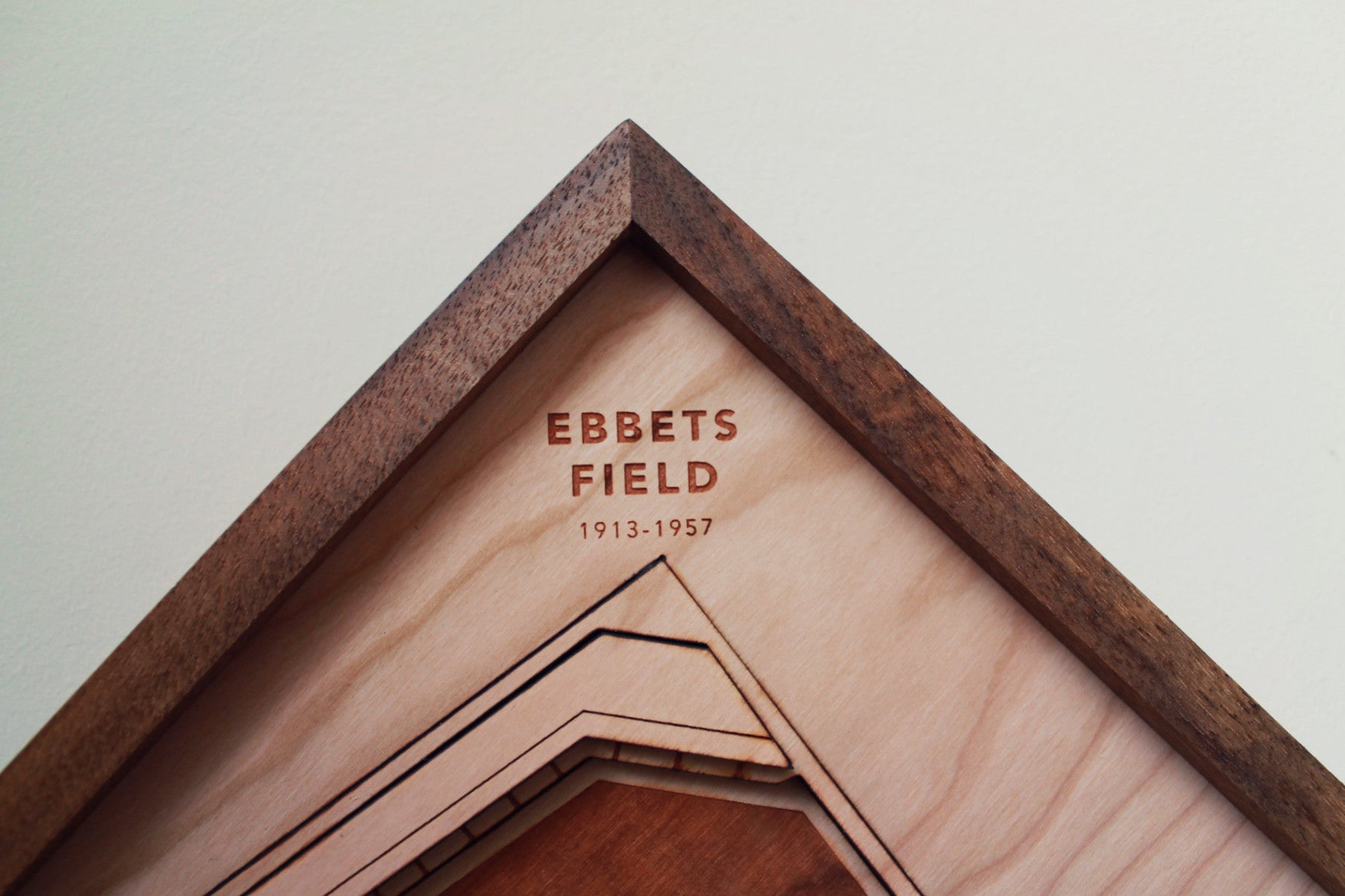 Ebbets Field replica showcasing intricate details and premium hardwood craftsmanship, framed in black walnut.