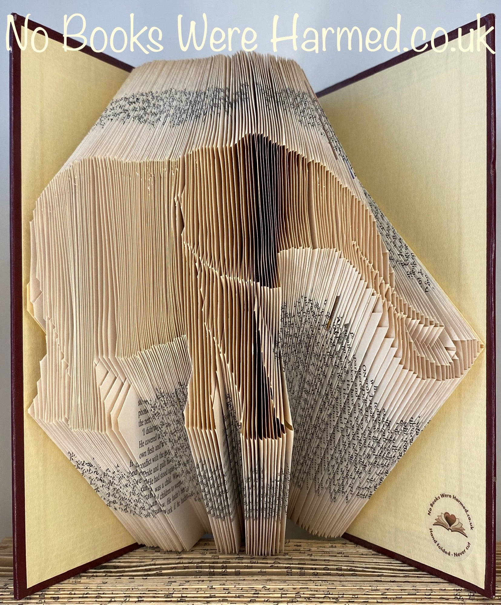 Hand-folded elephant art made from vintage book pages, showcasing intricate details and unique textures.