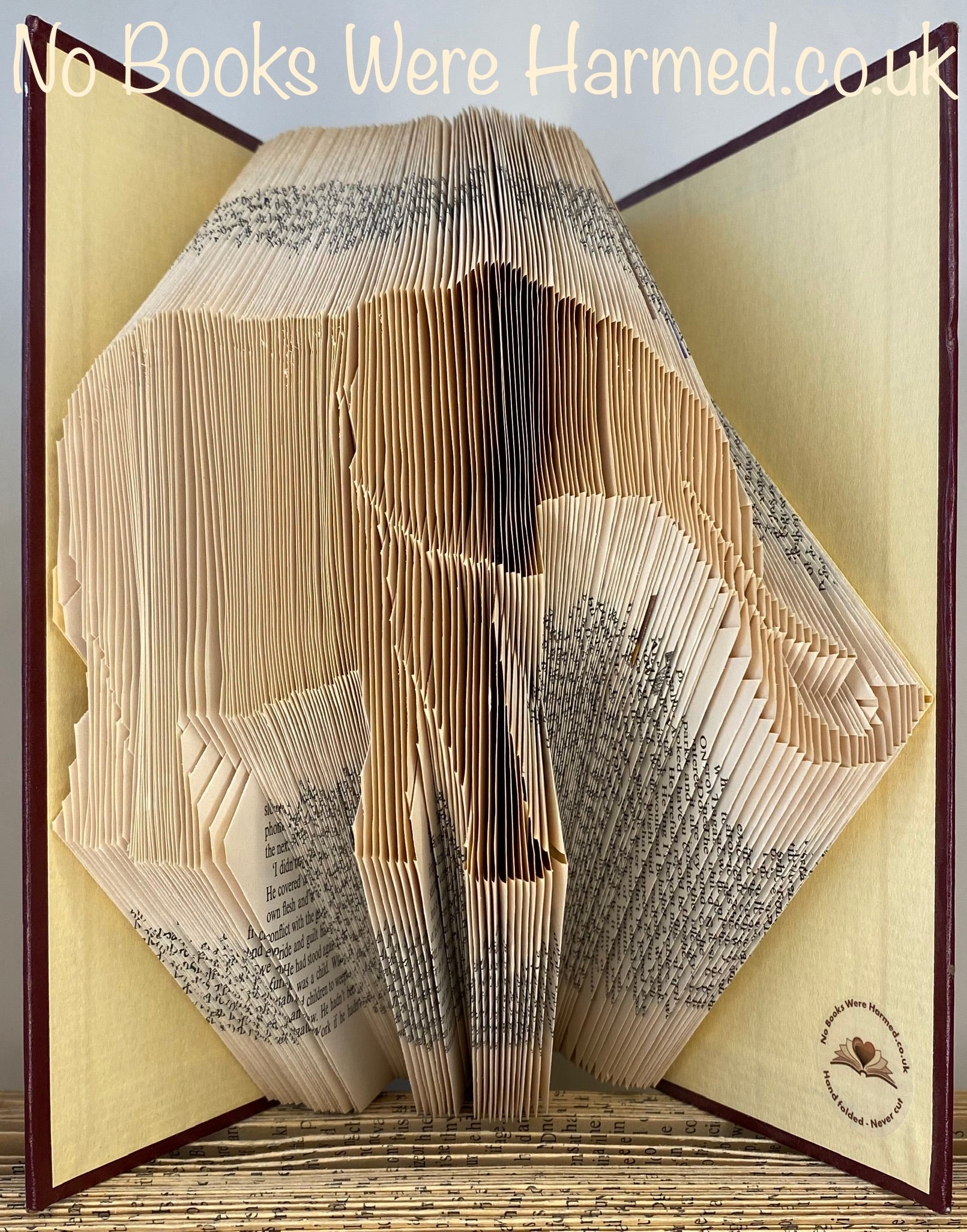 Hand-folded elephant art made from vintage book pages, showcasing intricate details and unique textures.