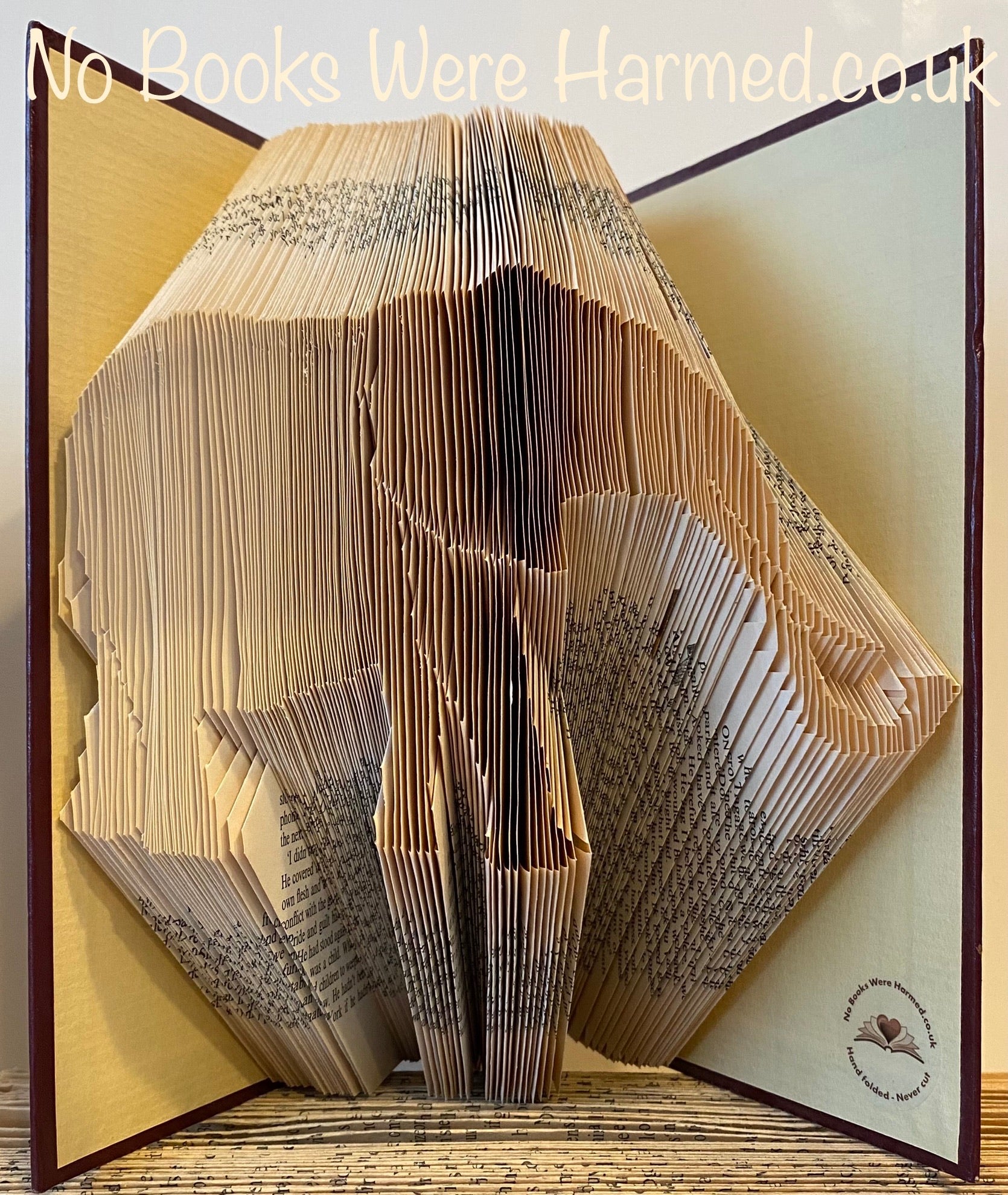 Hand-folded elephant art made from vintage book pages, showcasing intricate details and unique textures.