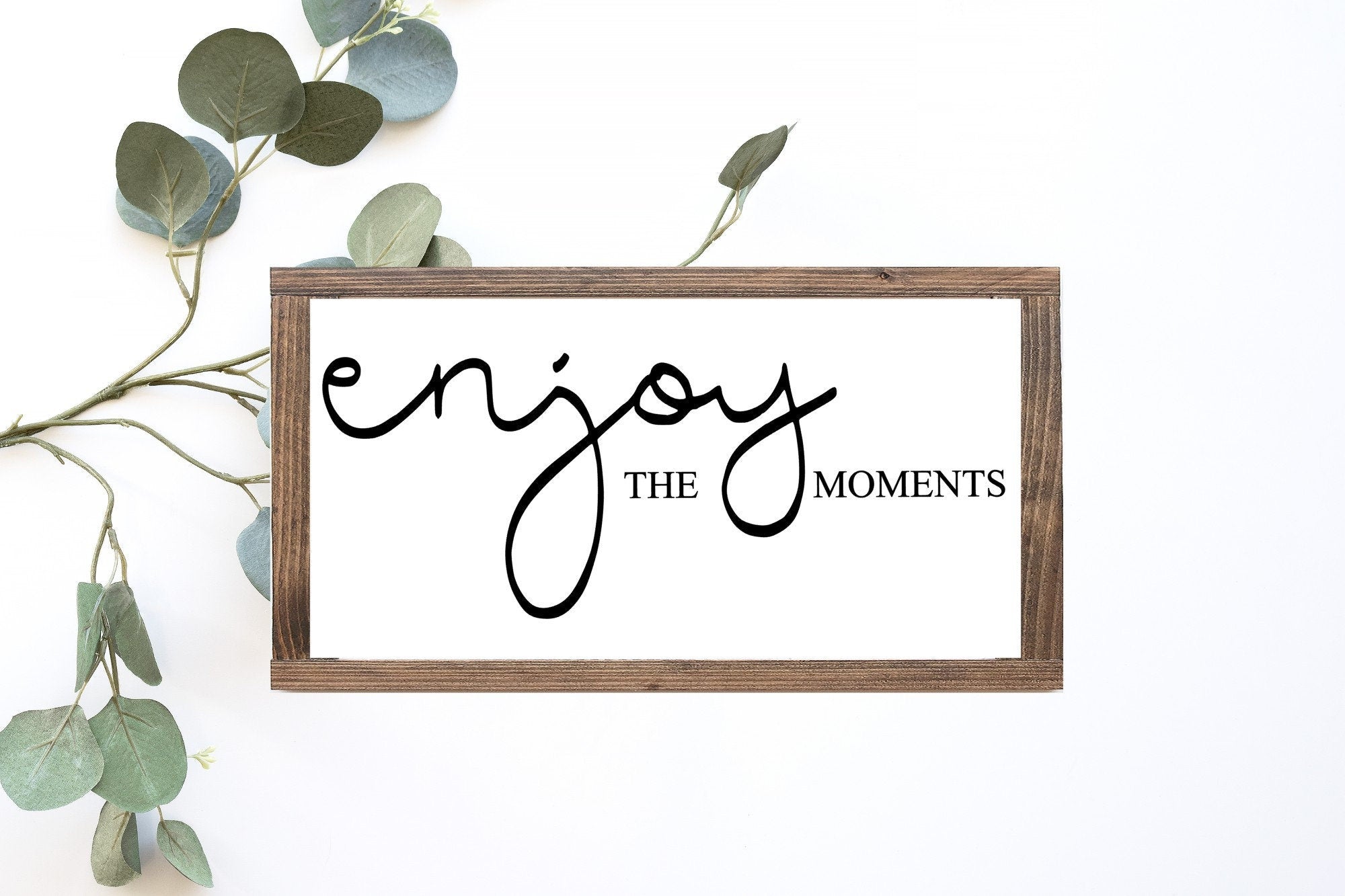 Enjoy The Moments Wood Sign in matte white finish, showcasing unique wood grain and lettering, perfect for home decor.