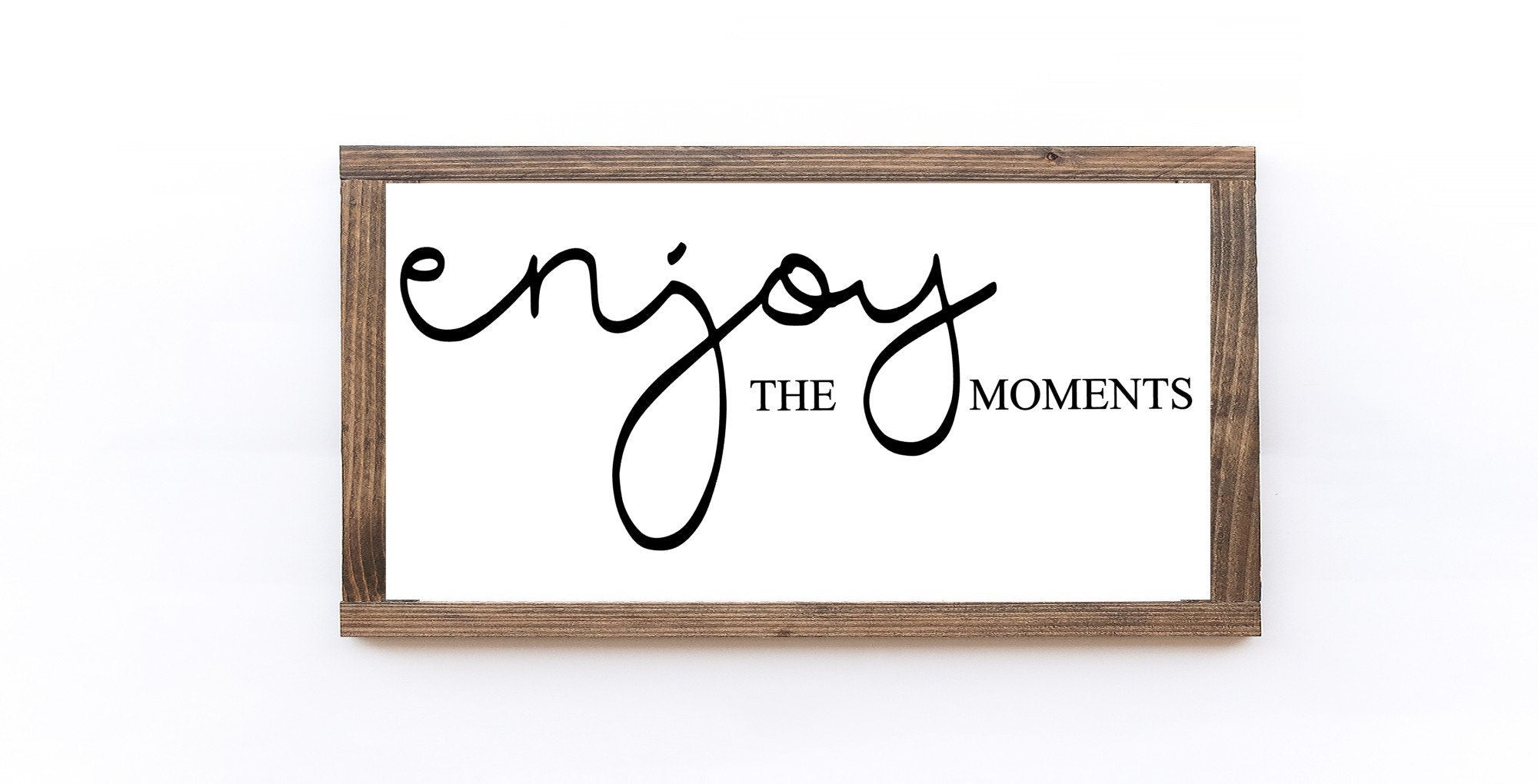 Enjoy The Moments Wood Sign in matte white finish, showcasing unique wood grain and lettering, perfect for home decor.