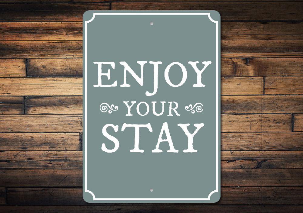 A decorative Enjoy Your Stay Sign made from high-quality aluminum, featuring customizable text and pre-drilled holes for easy mounting.