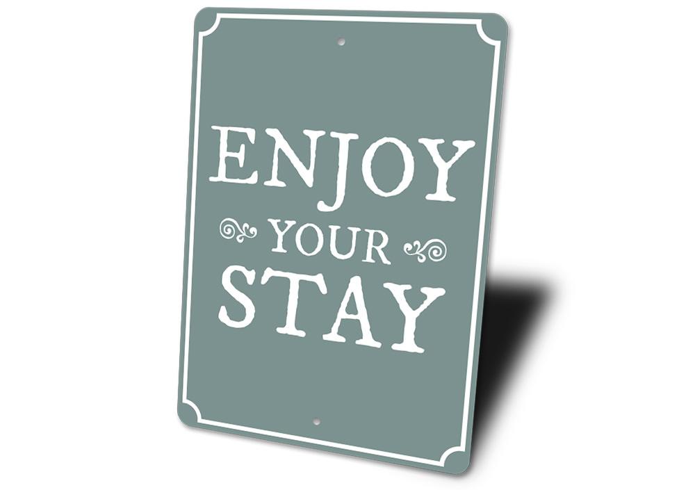 A decorative Enjoy Your Stay Sign made from high-quality aluminum, featuring customizable text and pre-drilled holes for easy mounting.