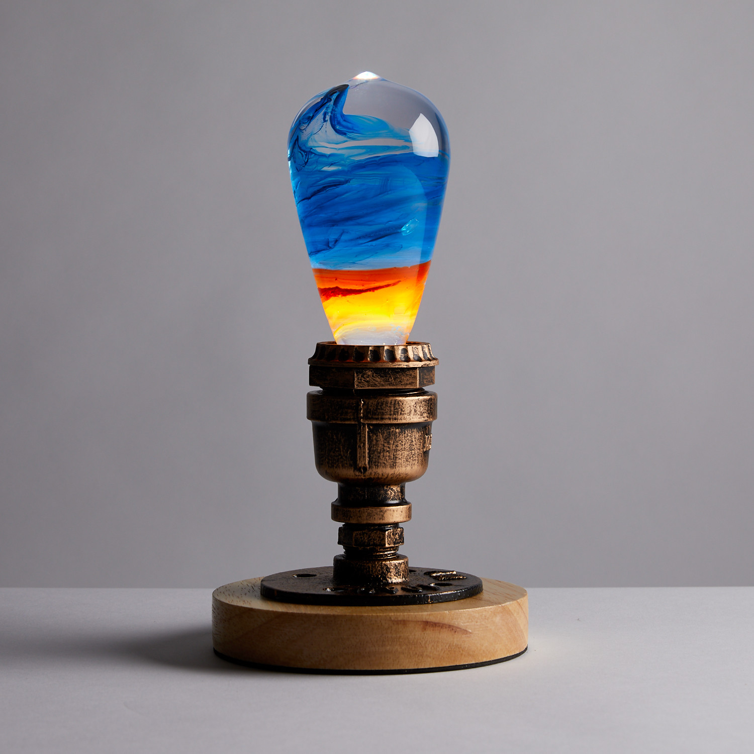 EP Light - Fire LED bulb with mixed colors and a handcrafted design, showcasing eco-friendly materials and a stylish beech wood base.