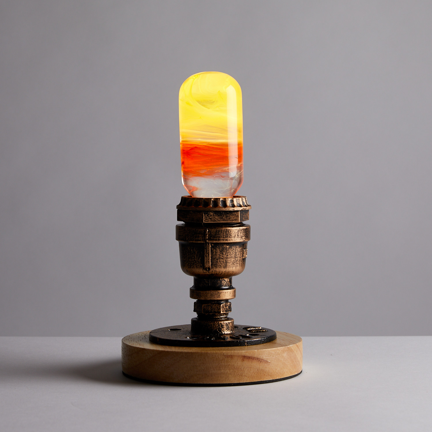 EP Light - Flame LED bulb with eco-friendly resin construction, showcasing its handcrafted design and stylish wooden base.