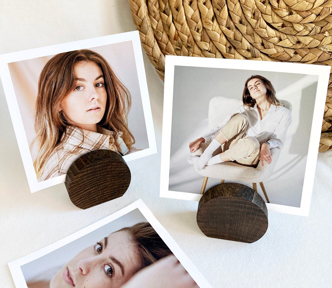 Espresso Moon Card Holder made of eco-friendly wood, displaying various photos and cards elegantly on a desk.