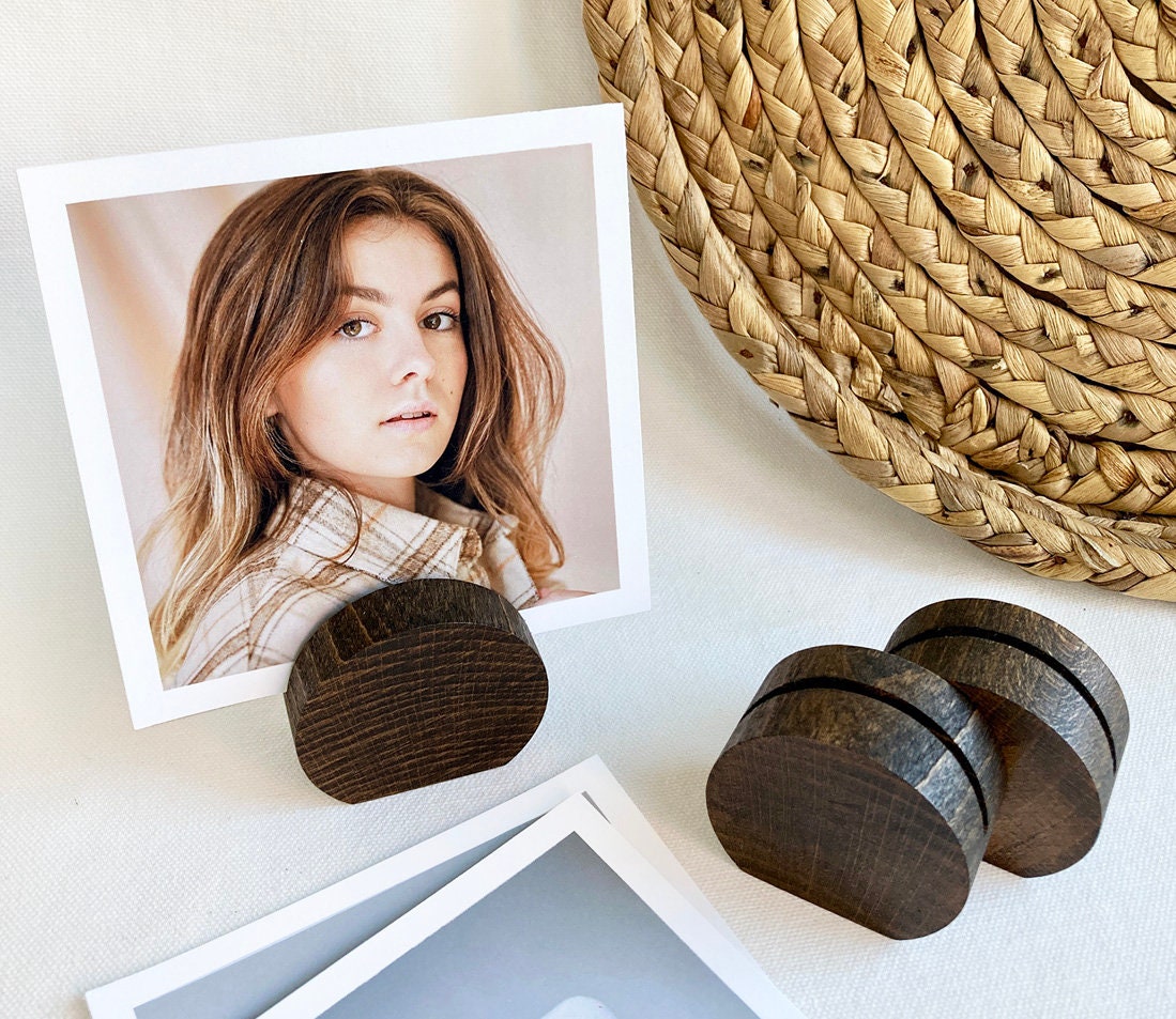 Espresso Moon Card Holder made of eco-friendly wood, displaying various photos and cards elegantly on a desk.