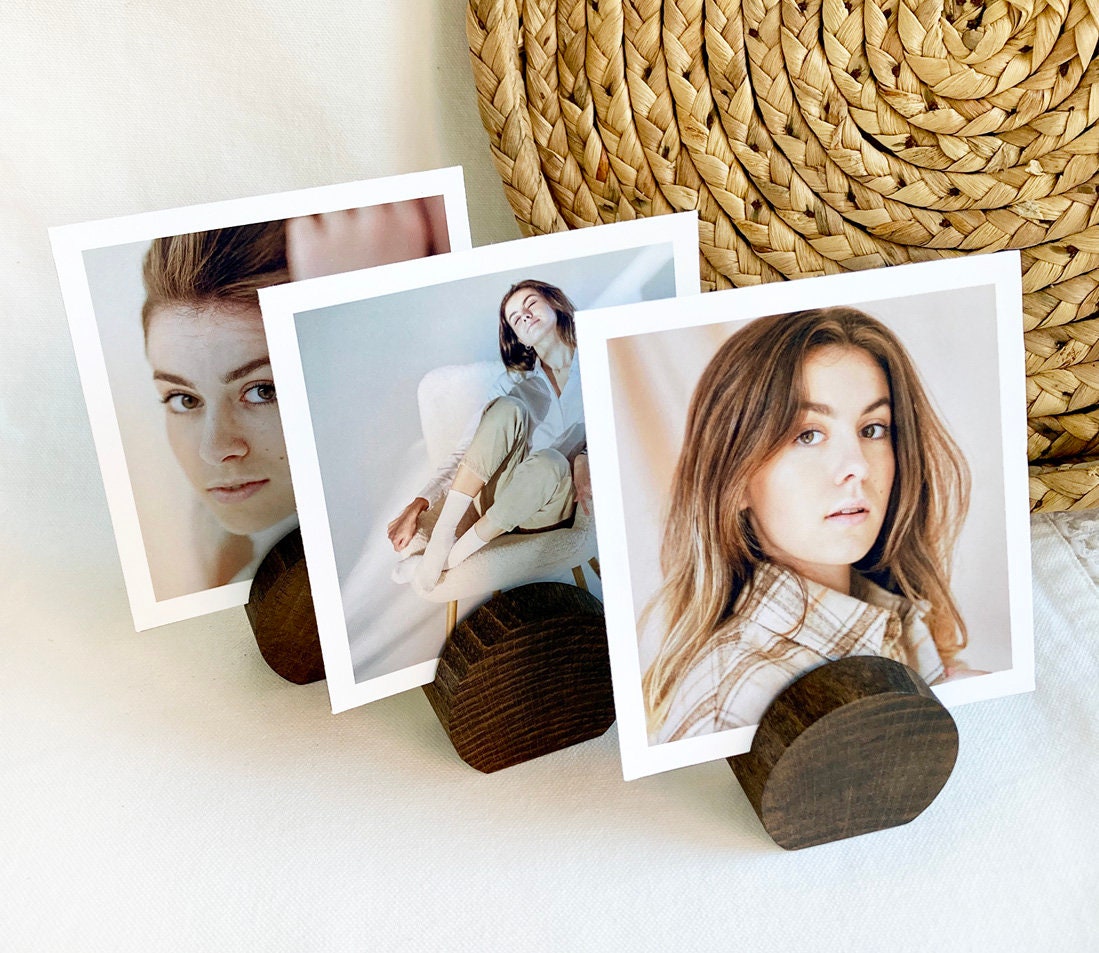 Espresso Moon Card Holder made of eco-friendly wood, displaying various photos and cards elegantly on a desk.