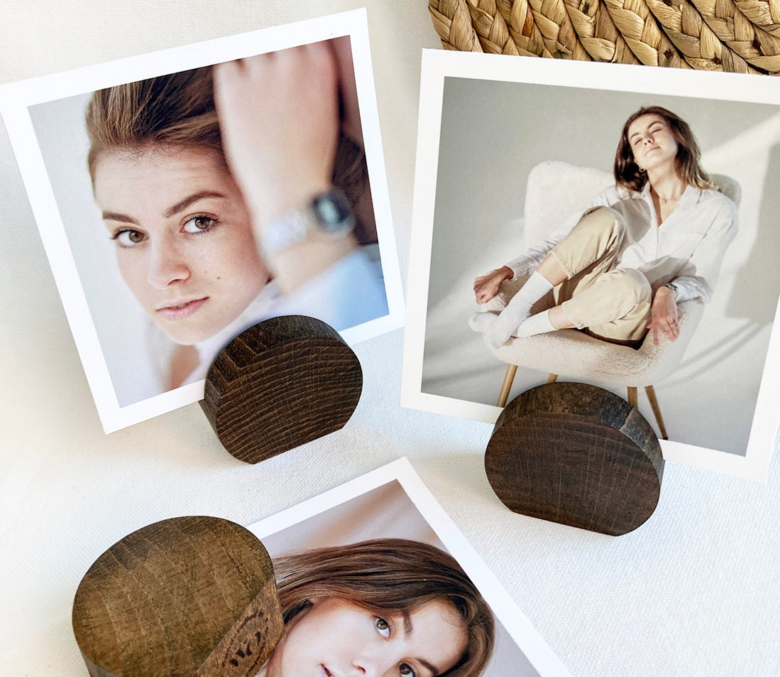 Espresso Moon Card Holder made of eco-friendly wood, displaying various photos and cards elegantly on a desk.