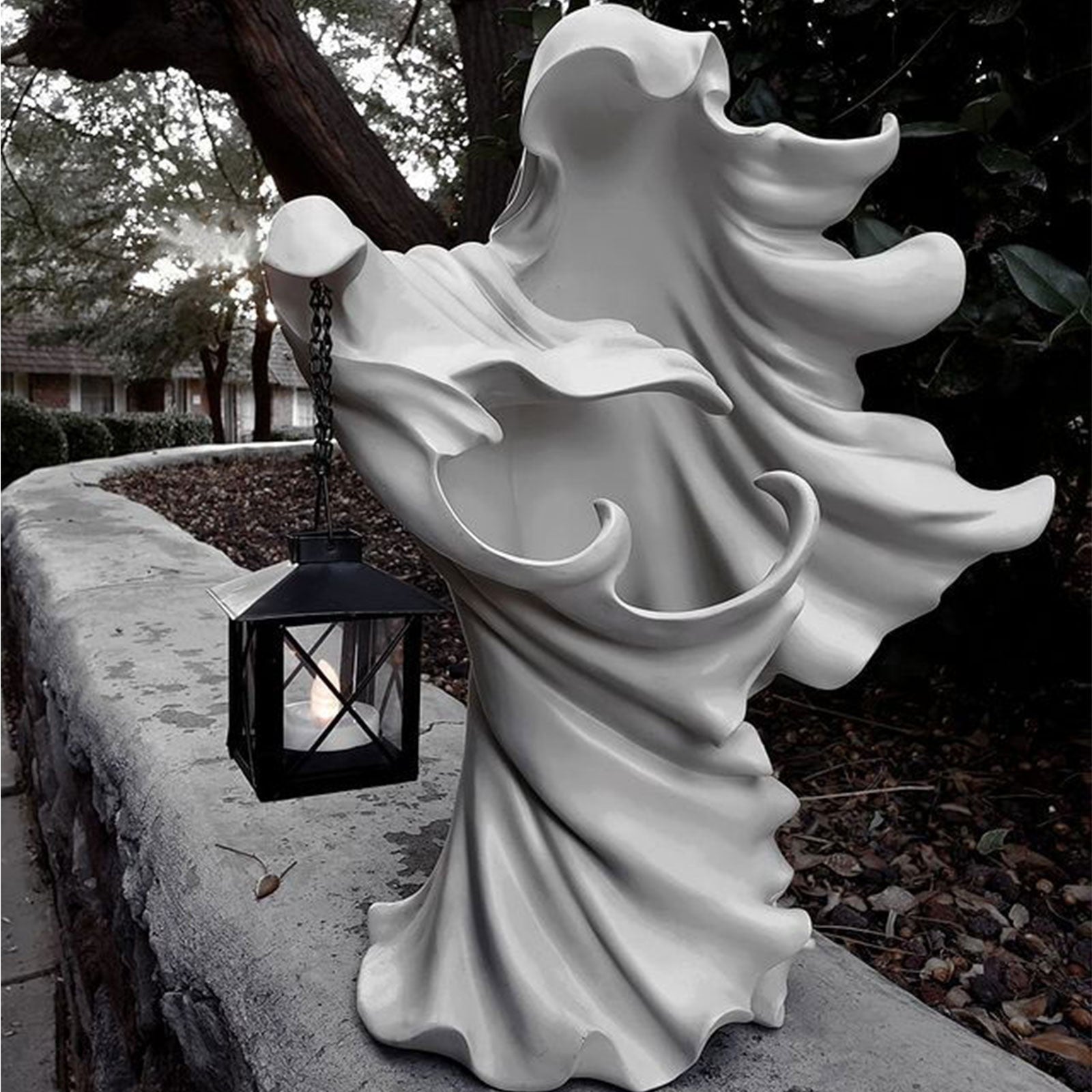 Faceless Ghost Sculpture made of resin, featuring a hand-carved design with a lantern, perfect for Halloween decoration.