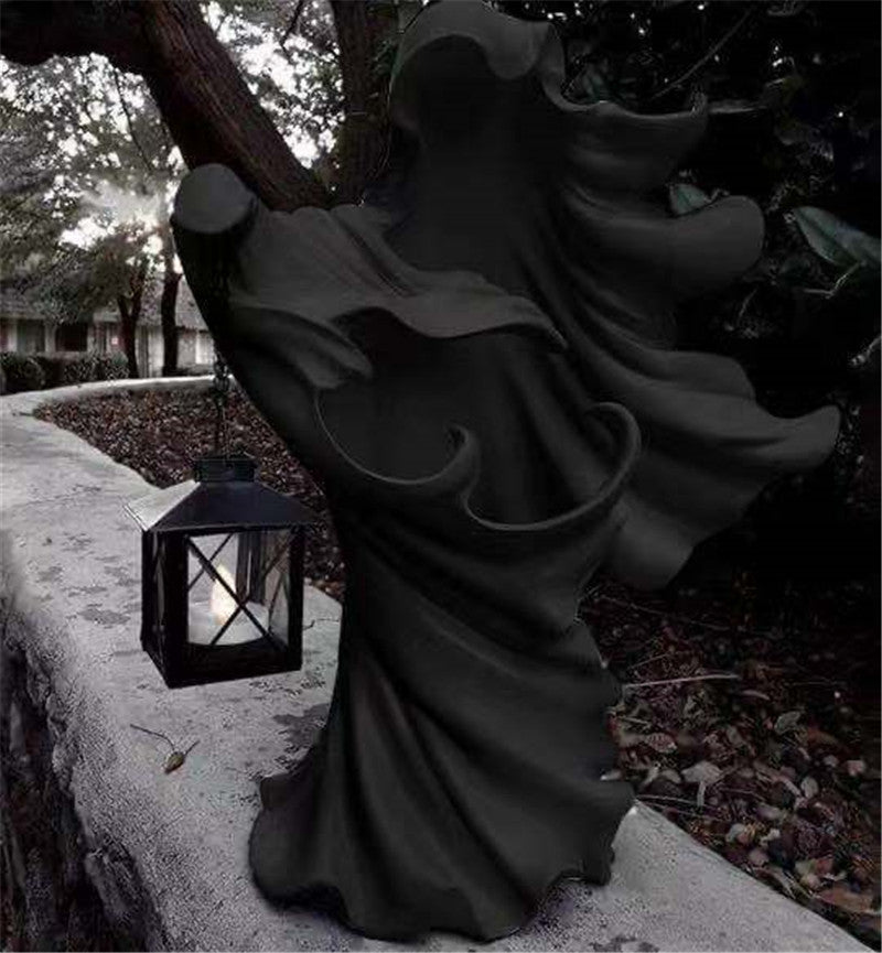 Faceless Ghost Sculpture made of resin, featuring a hand-carved design with a lantern, perfect for Halloween decoration.