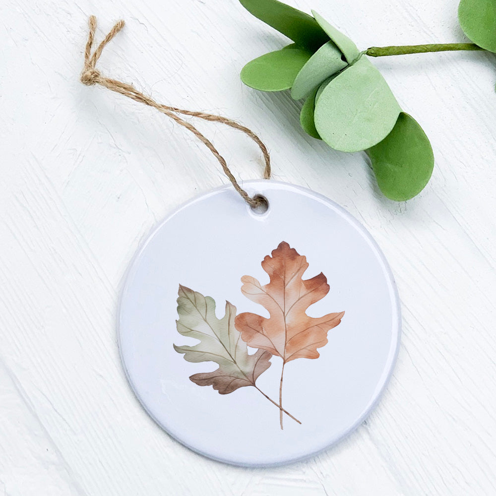 A beautifully crafted porcelain ornament featuring fall oak leaves design, showcasing vibrant colors and intricate details.