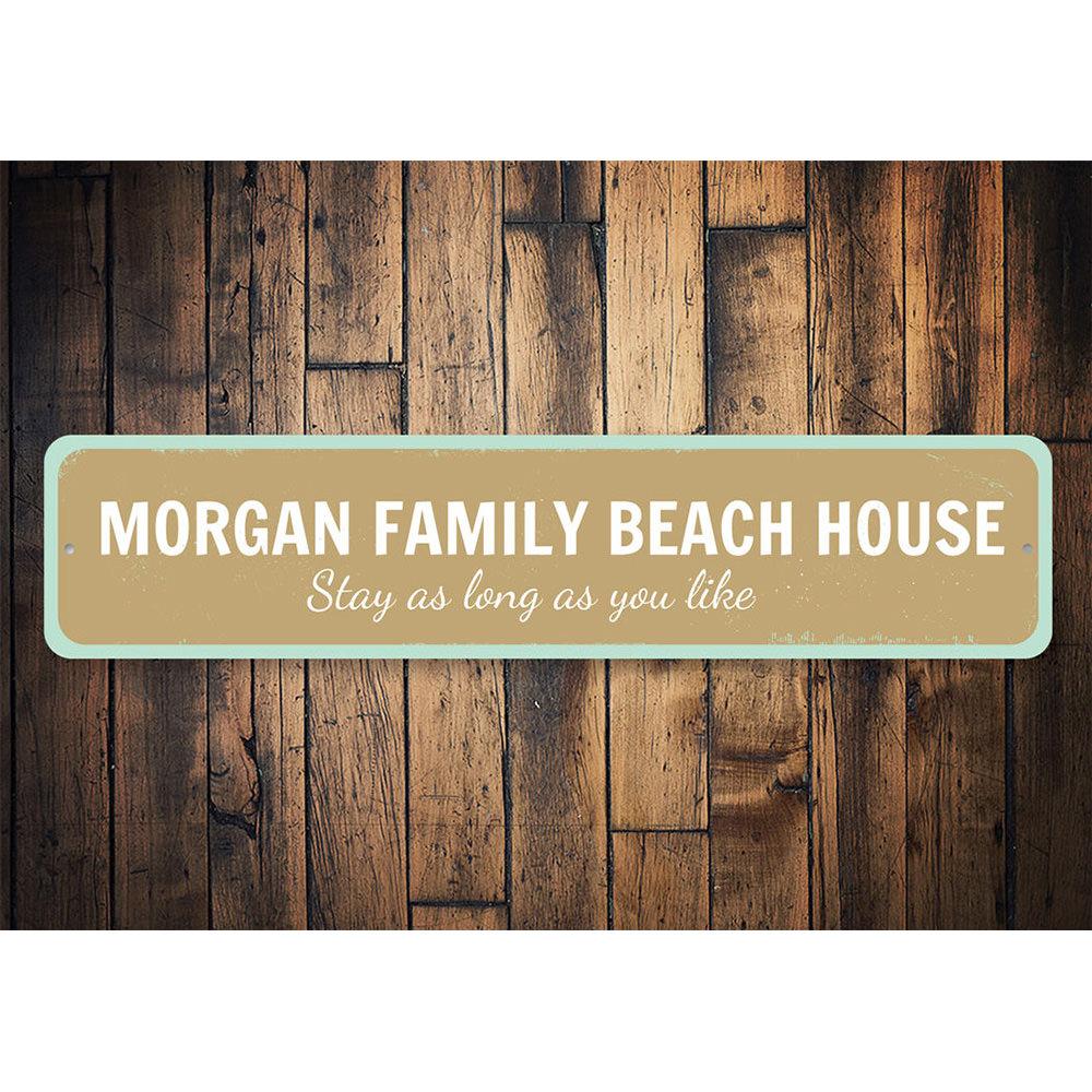 A customizable Family Beach House Sign made of durable aluminum, featuring a coastal design perfect for beach houses and seaside decor.