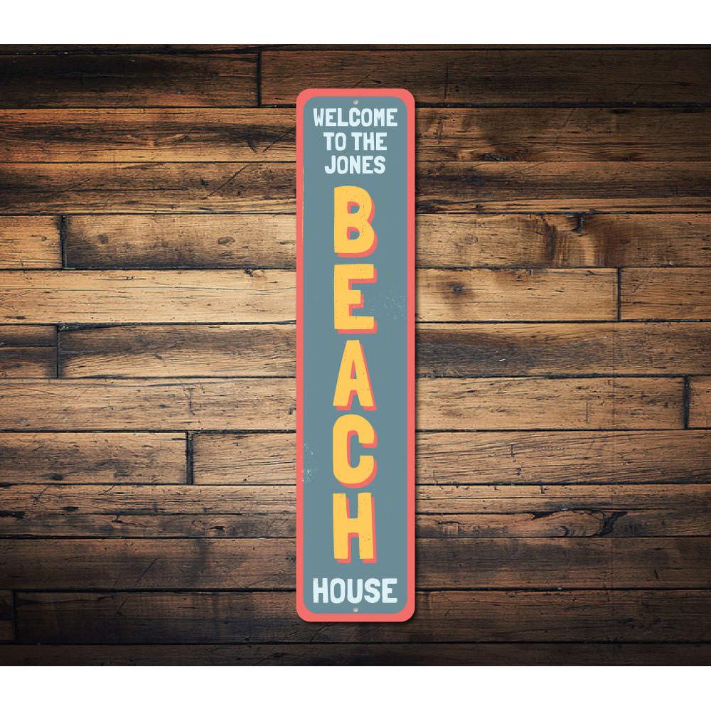 Family Beach House Welcome Vertical Sign made of aluminum, featuring a welcoming design perfect for beach-themed decor.