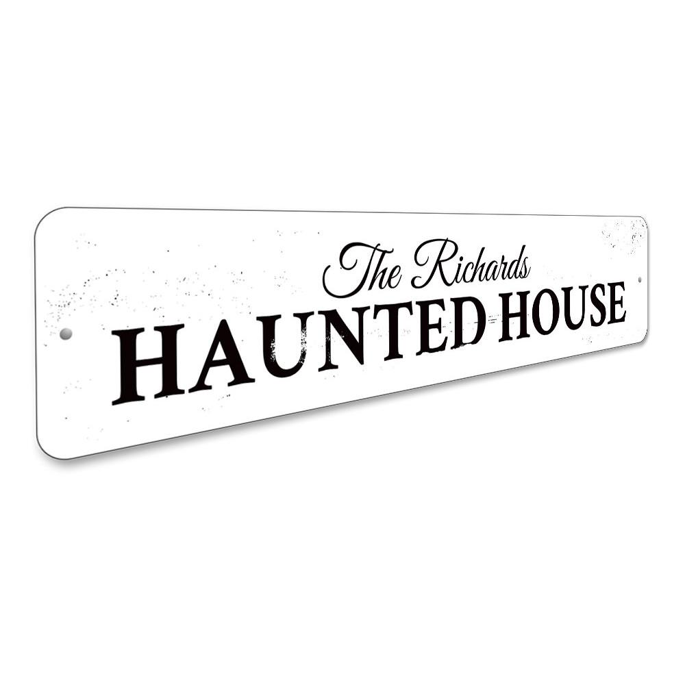 A spooky Family Haunted House Sign made of durable aluminum, featuring eerie graphics perfect for Halloween decor.