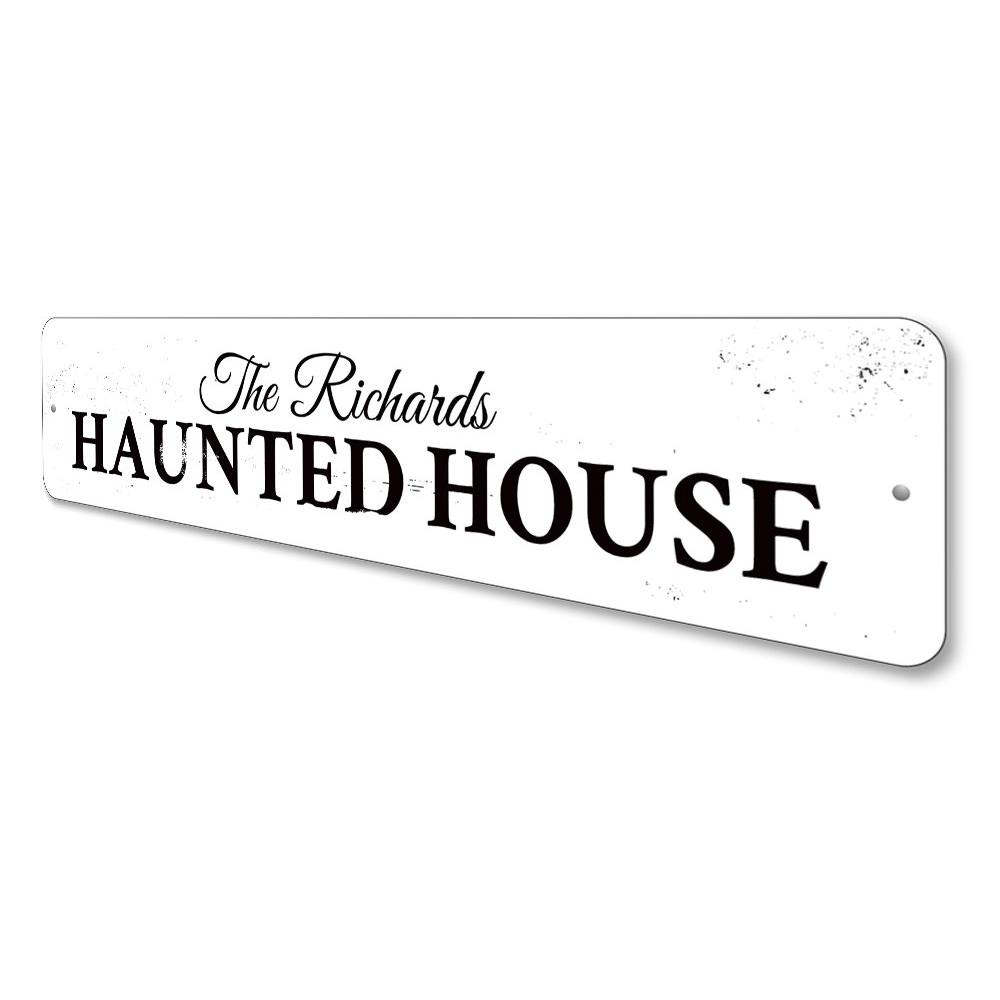 A spooky Family Haunted House Sign made of durable aluminum, featuring eerie graphics perfect for Halloween decor.