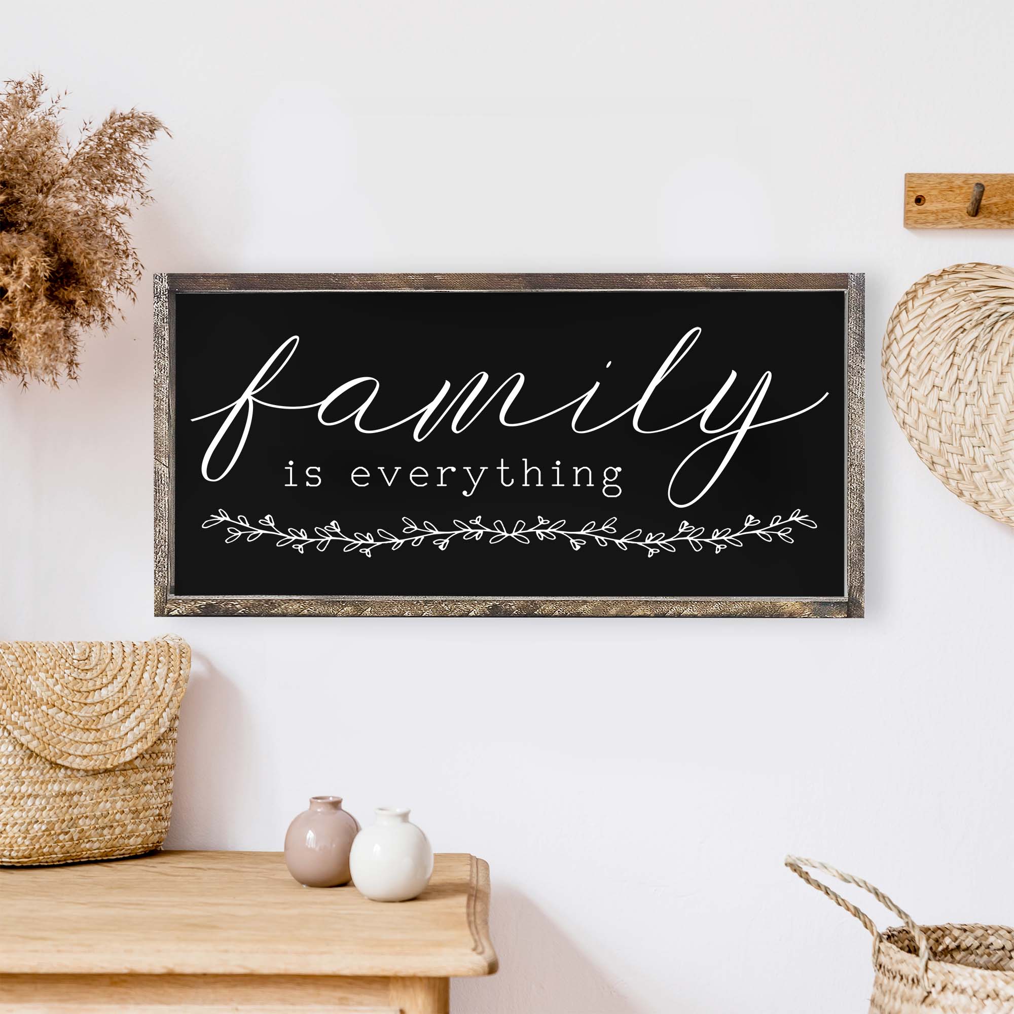 Family Is Everything Wood Sign featuring a wreath design, available in black or white, perfect for home decor.