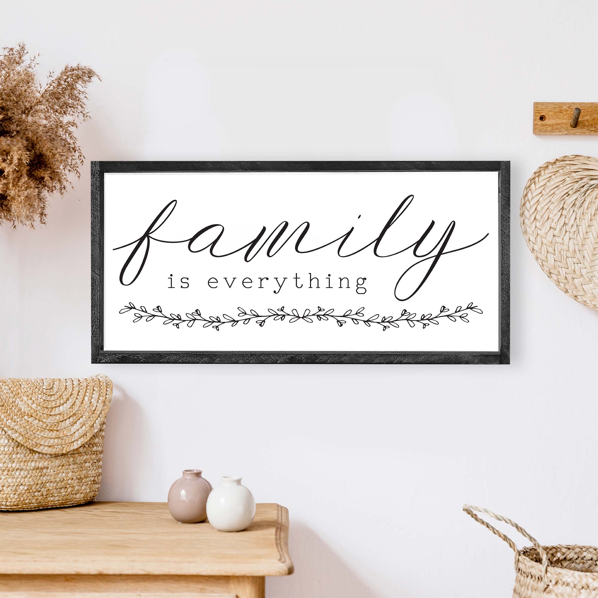 Family Is Everything Wood Sign featuring a wreath design, available in black or white, perfect for home decor.