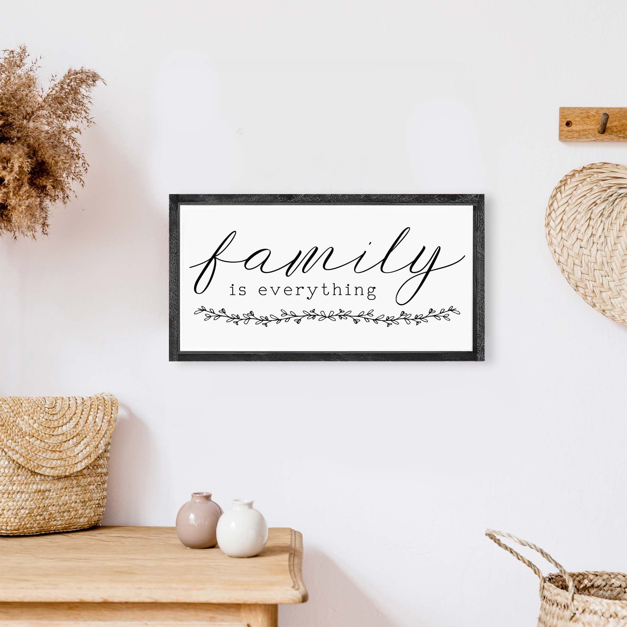 Family Is Everything Wood Sign featuring a wreath design, available in black or white, perfect for home decor.