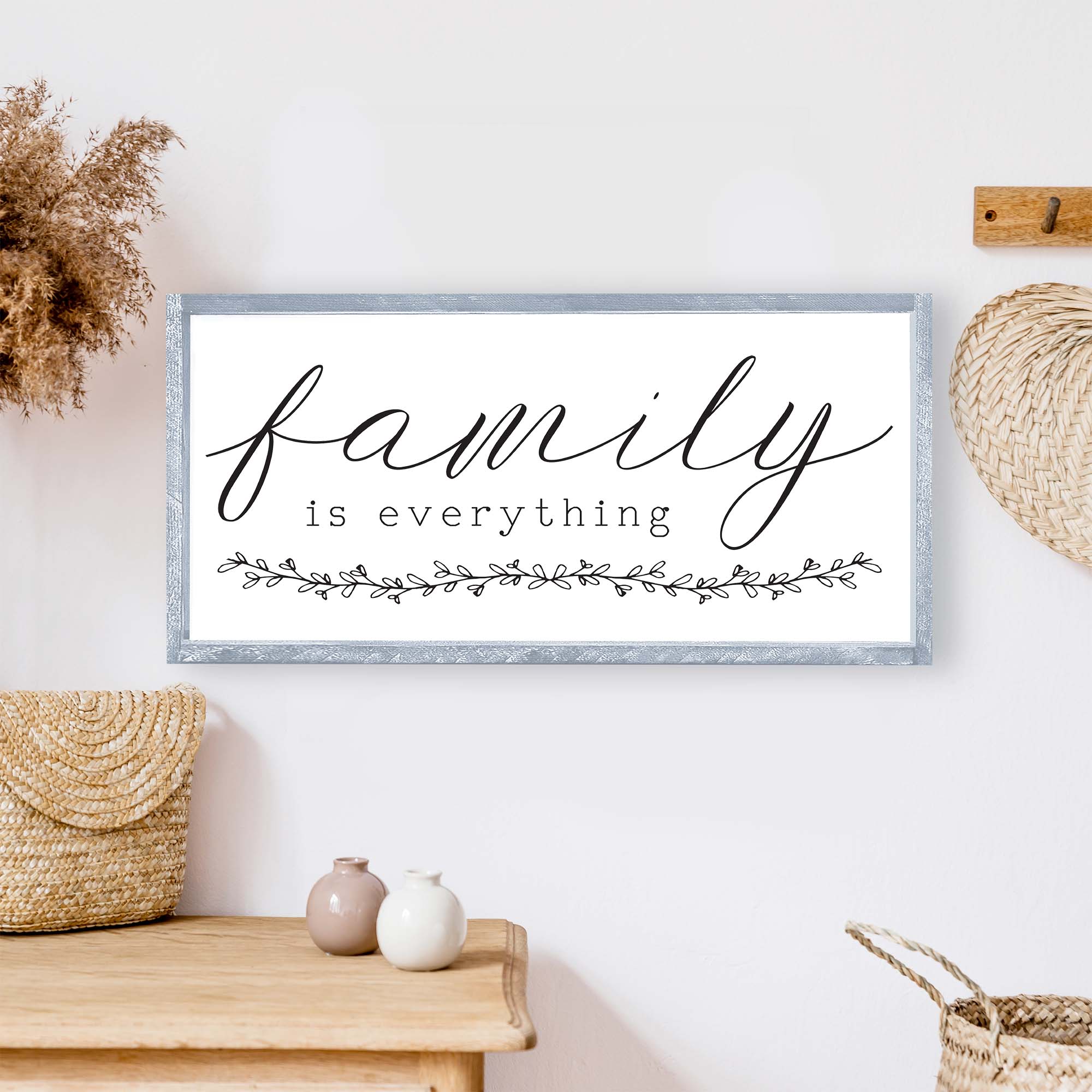 Family Is Everything Wood Sign featuring a wreath design, available in black or white, perfect for home decor.