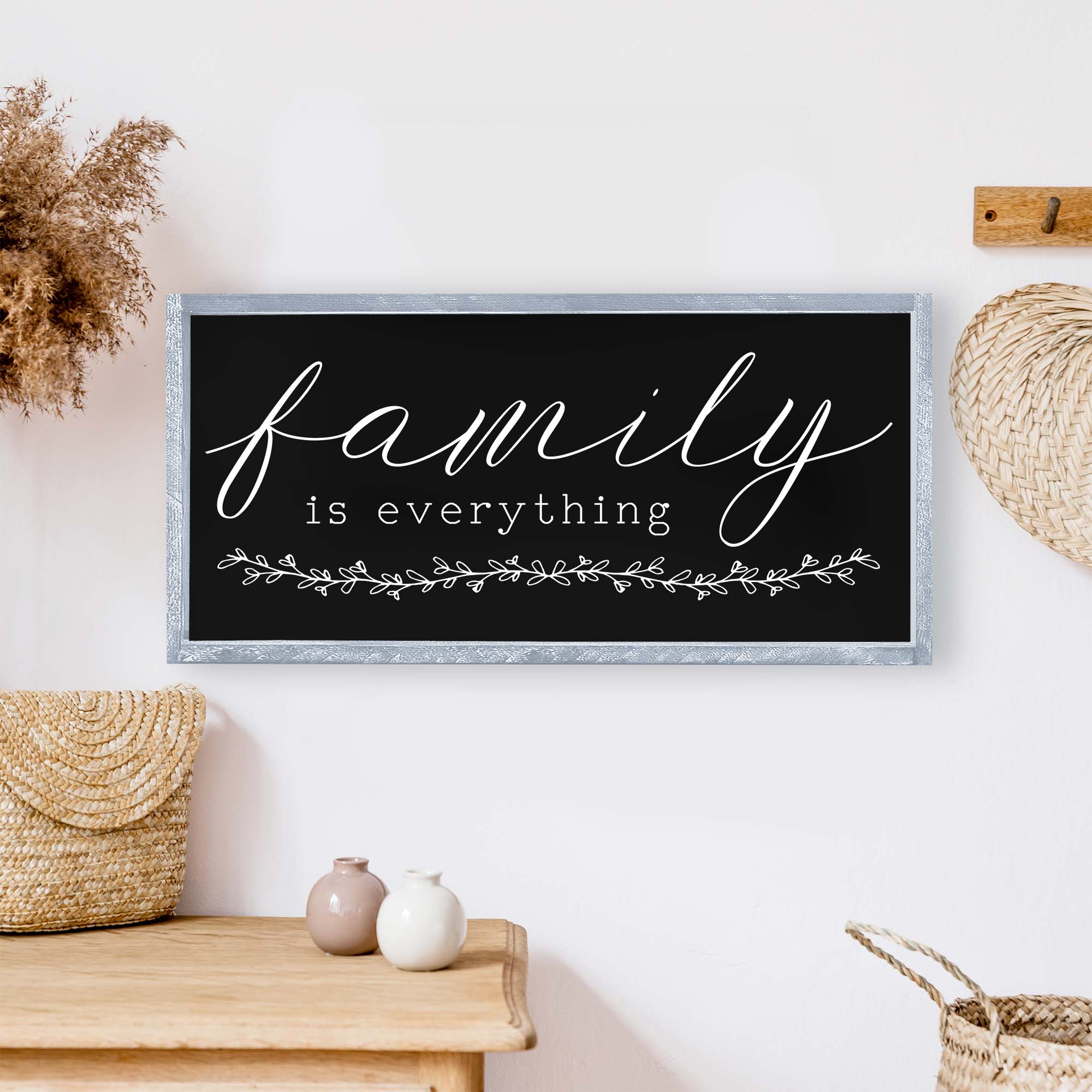 Family Is Everything Wood Sign featuring a wreath design, available in black or white, perfect for home decor.