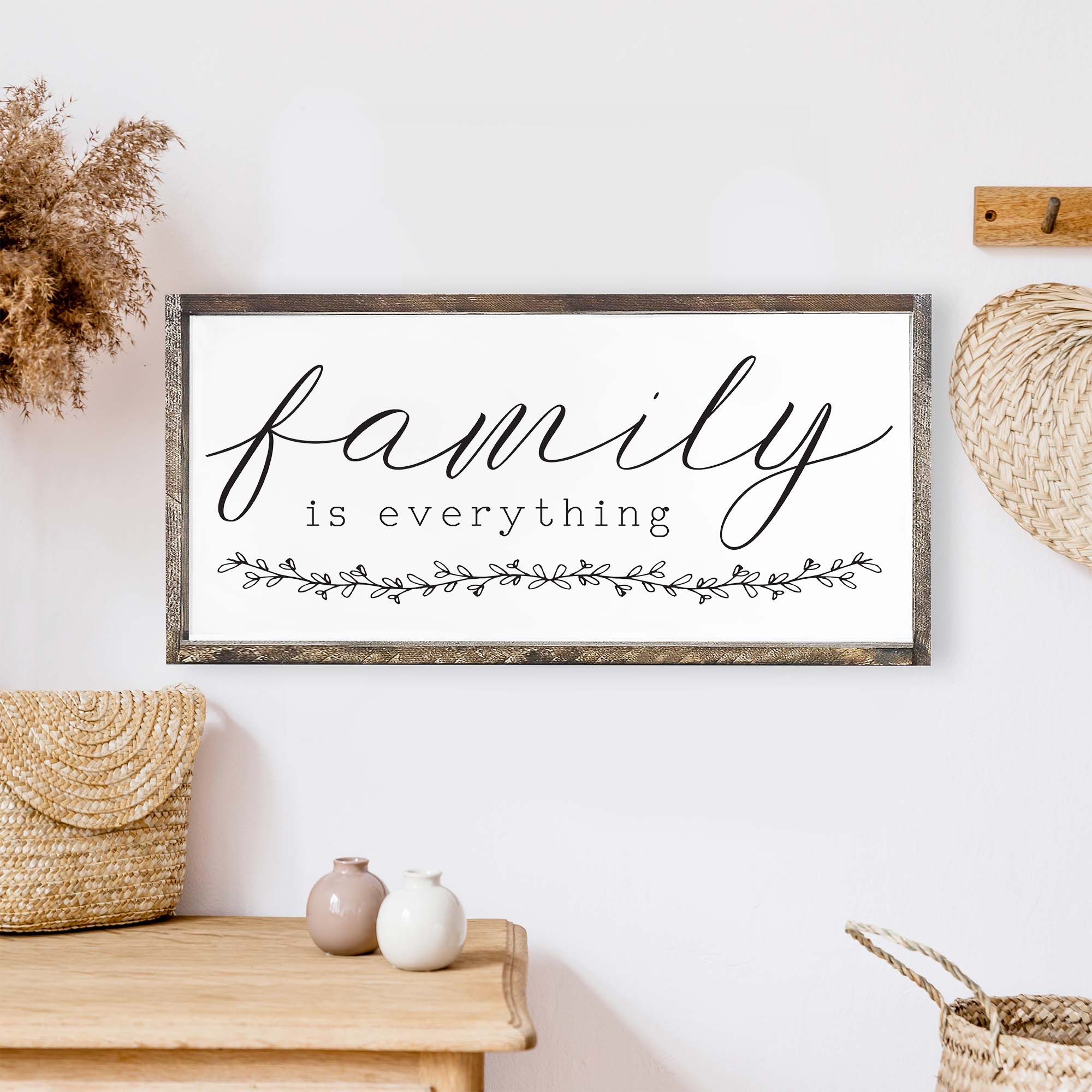 Family Is Everything Wood Sign featuring a wreath design, available in black or white, perfect for home decor.