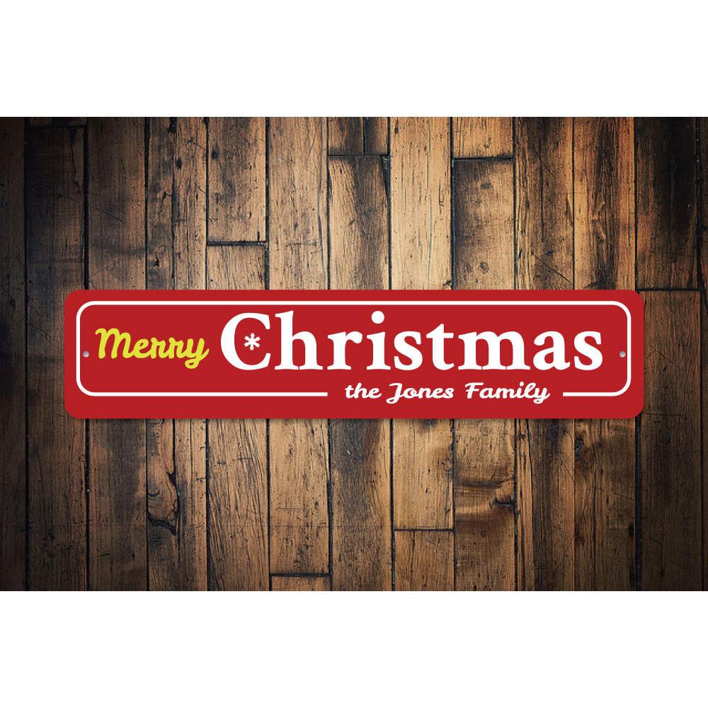 A decorative Family Merry Christmas Snowflake Sign featuring a festive snowflake design, perfect for holiday decor.