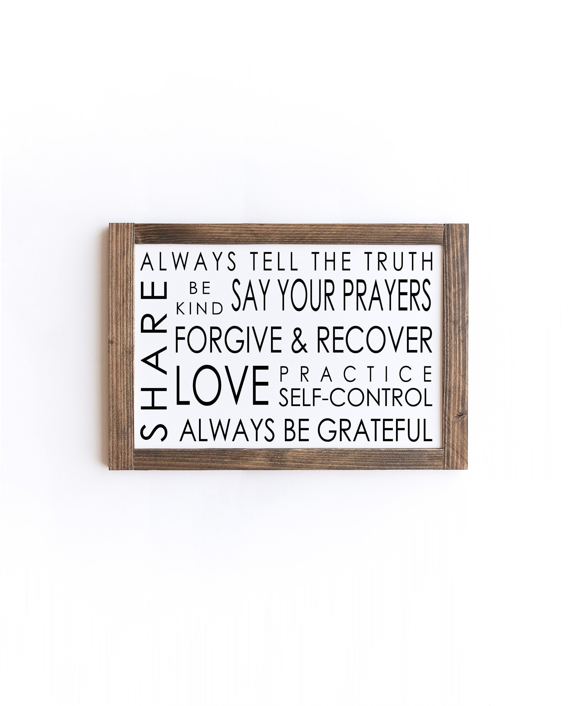 A beautifully crafted Family Rules Wood Sign made from 100% wood, featuring a matte white background with painted lettering, showcasing unique wood grain patterns.