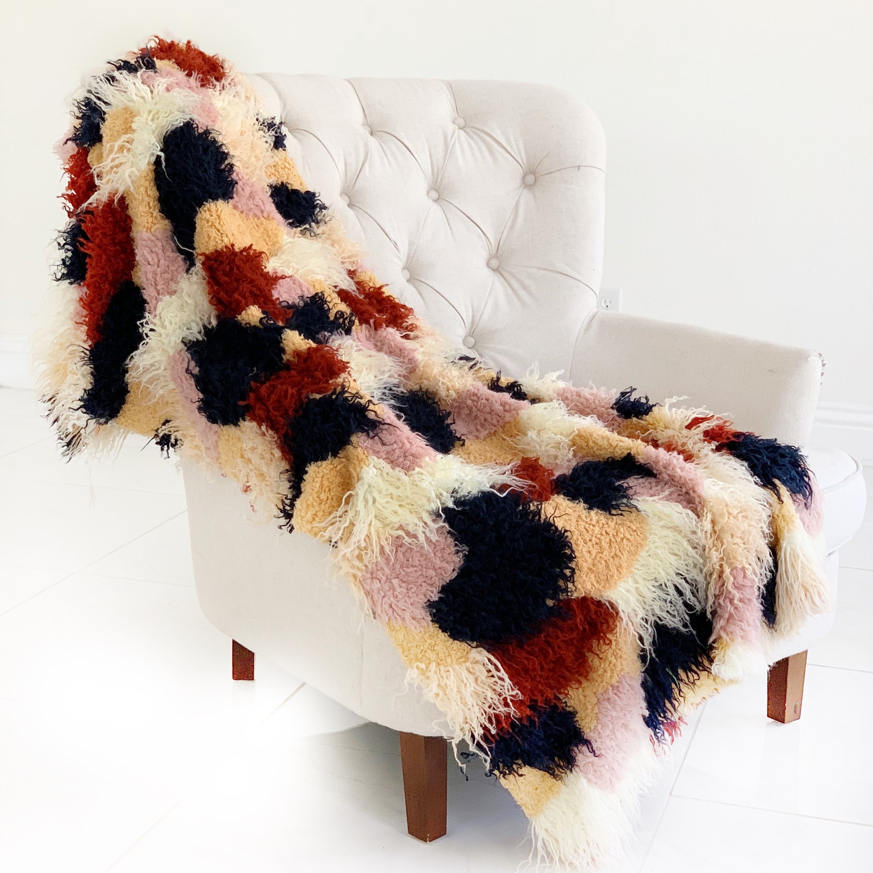 Fanciful Boho Plush Handmade Luxury Faux Fur Throw in vibrant red, white, and blue colors, showcasing its plush texture and reversible design.