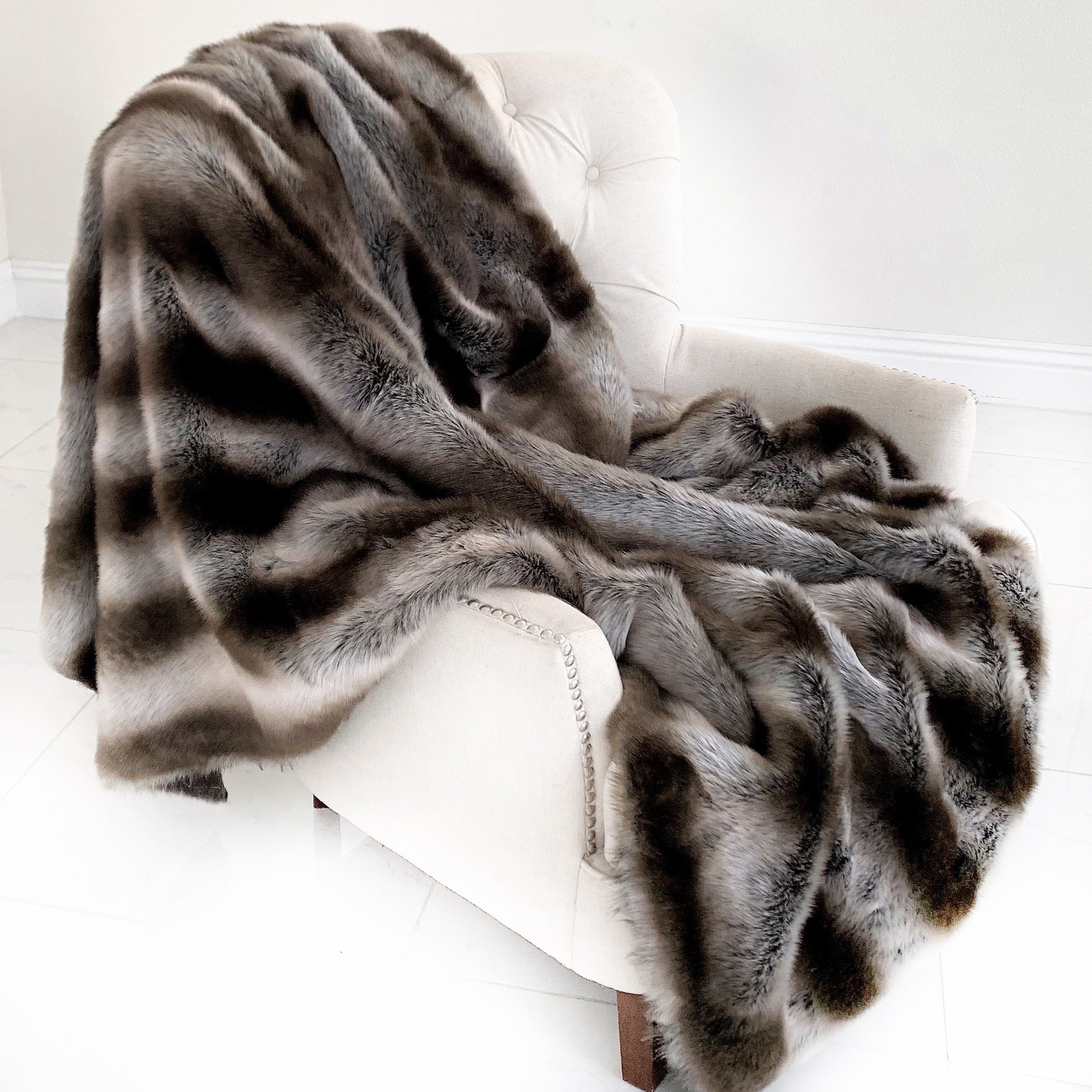 Fancy Gray Silver Chinchilla Faux Fur Handmade Luxury Throw showcasing its plush texture and reversible design in silver and gray colors.