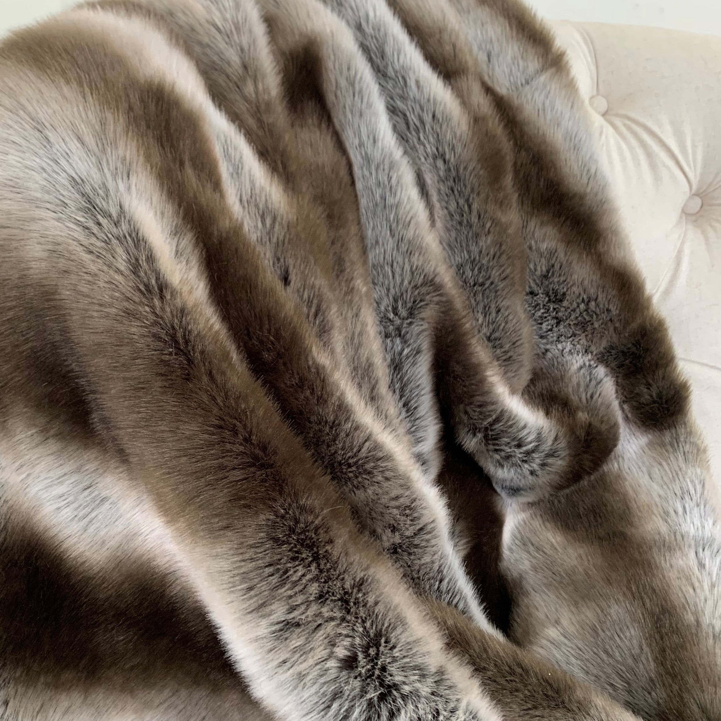 Fancy Gray Silver Chinchilla Faux Fur Handmade Luxury Throw showcasing its plush texture and reversible design in silver and gray colors.