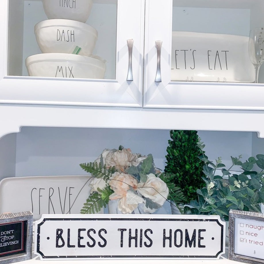 Farmhouse Chic hanging wood sign with 'Bless This Home' and 'Eat Good Food' messages, featuring a rustic white and black design.