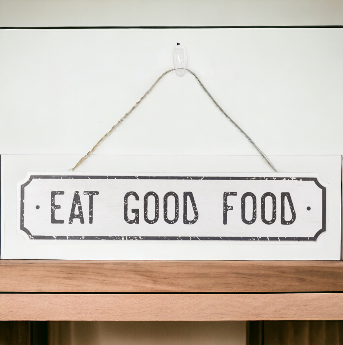 Farmhouse Chic hanging wood sign with 'Bless This Home' and 'Eat Good Food' messages, featuring a rustic white and black design.