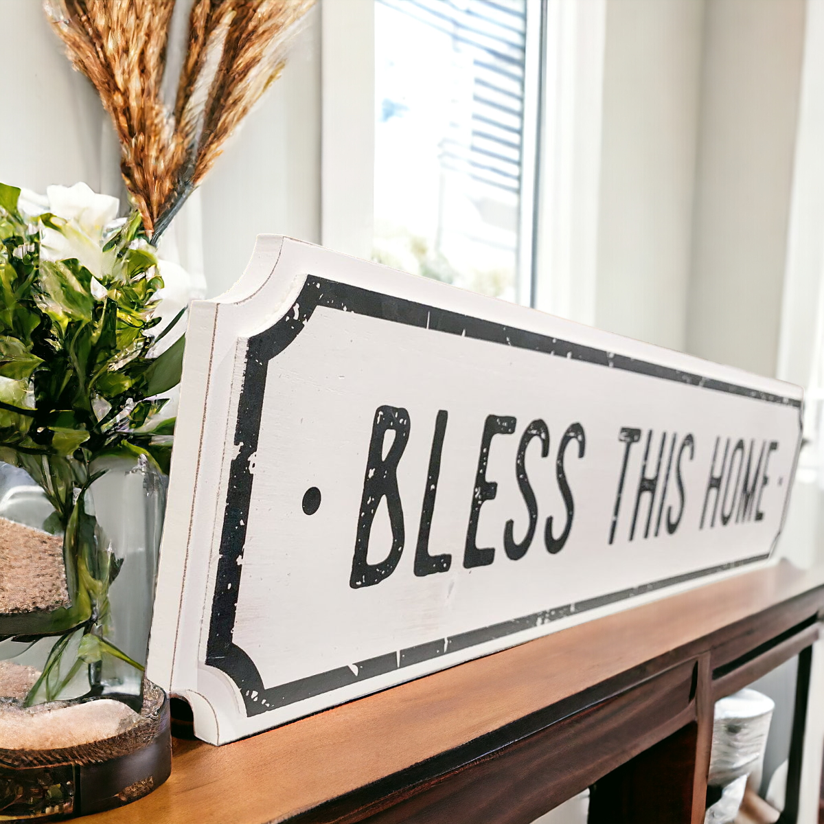 Farmhouse Chic hanging wood sign with 'Bless This Home' and 'Eat Good Food' messages, featuring a rustic white and black design.