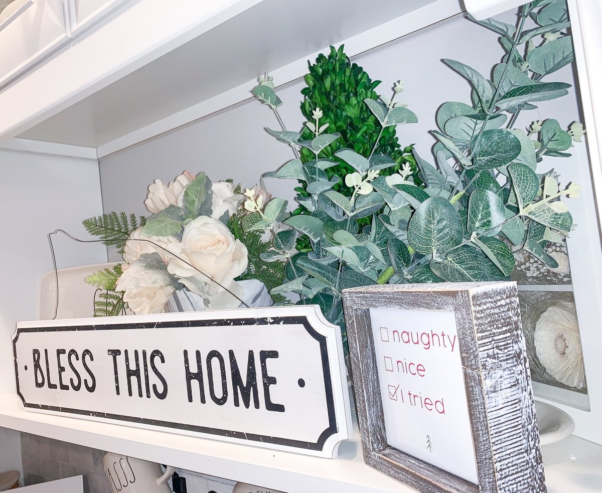 Farmhouse Chic hanging wood sign with 'Bless This Home' and 'Eat Good Food' messages, featuring a rustic white and black design.