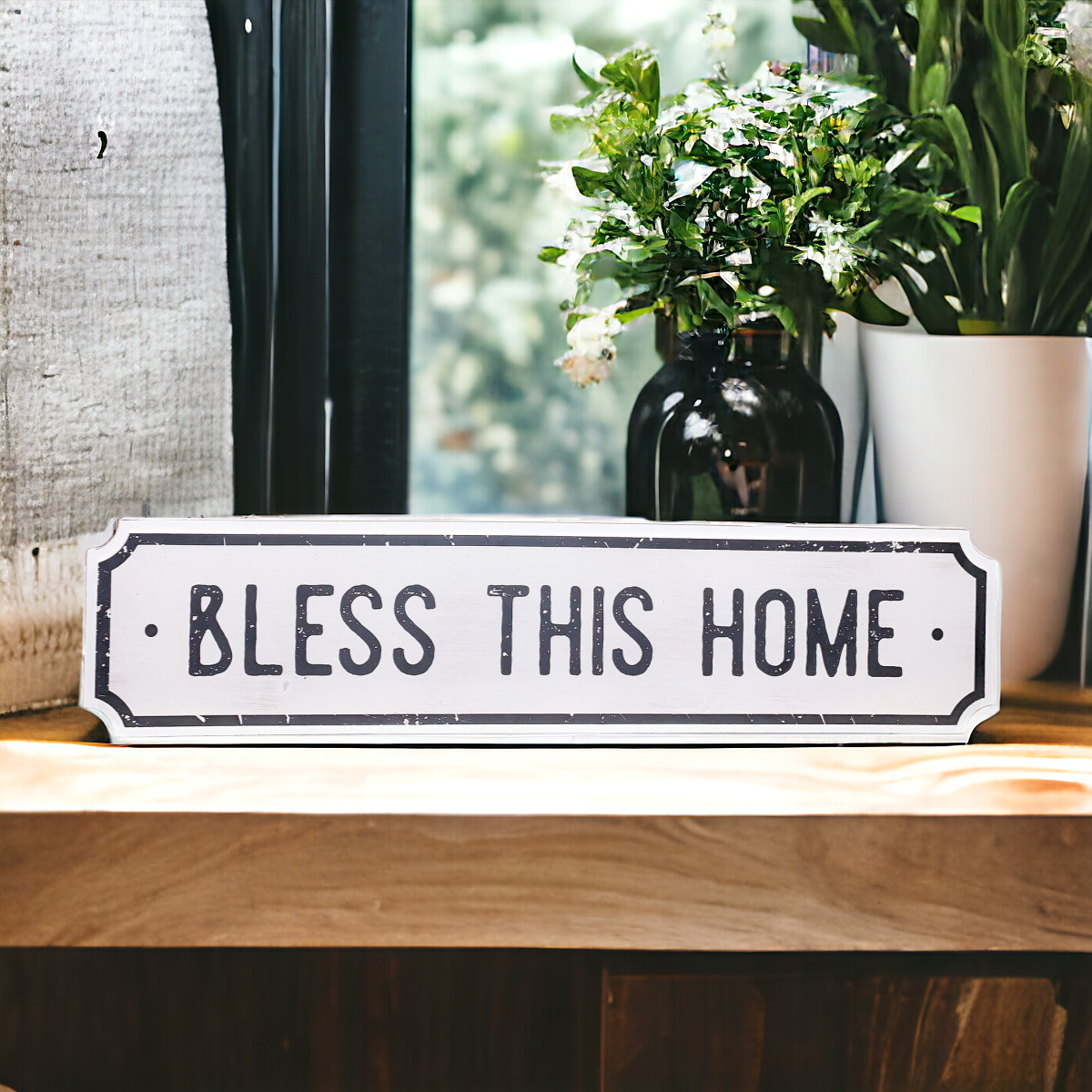 Farmhouse Chic hanging wood sign with 'Bless This Home' and 'Eat Good Food' messages, featuring a rustic white and black design.