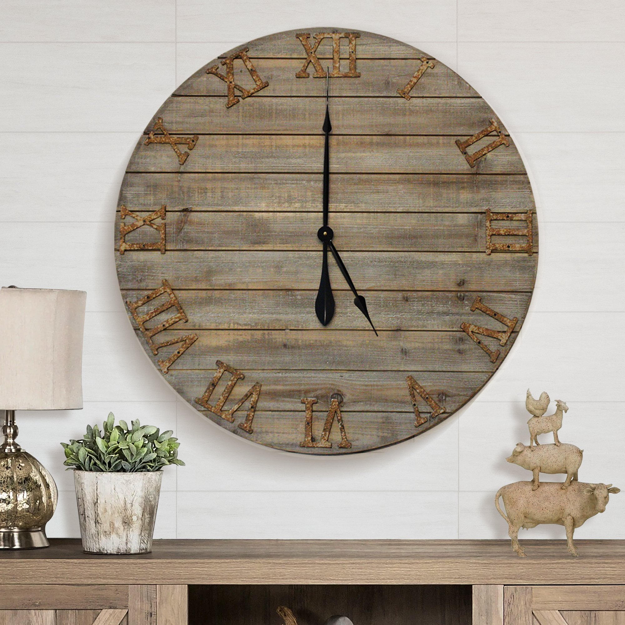 A 30-inch oversized farmhouse wall clock made of real wood with cast iron numbers, showcasing a beautifully distressed finish.