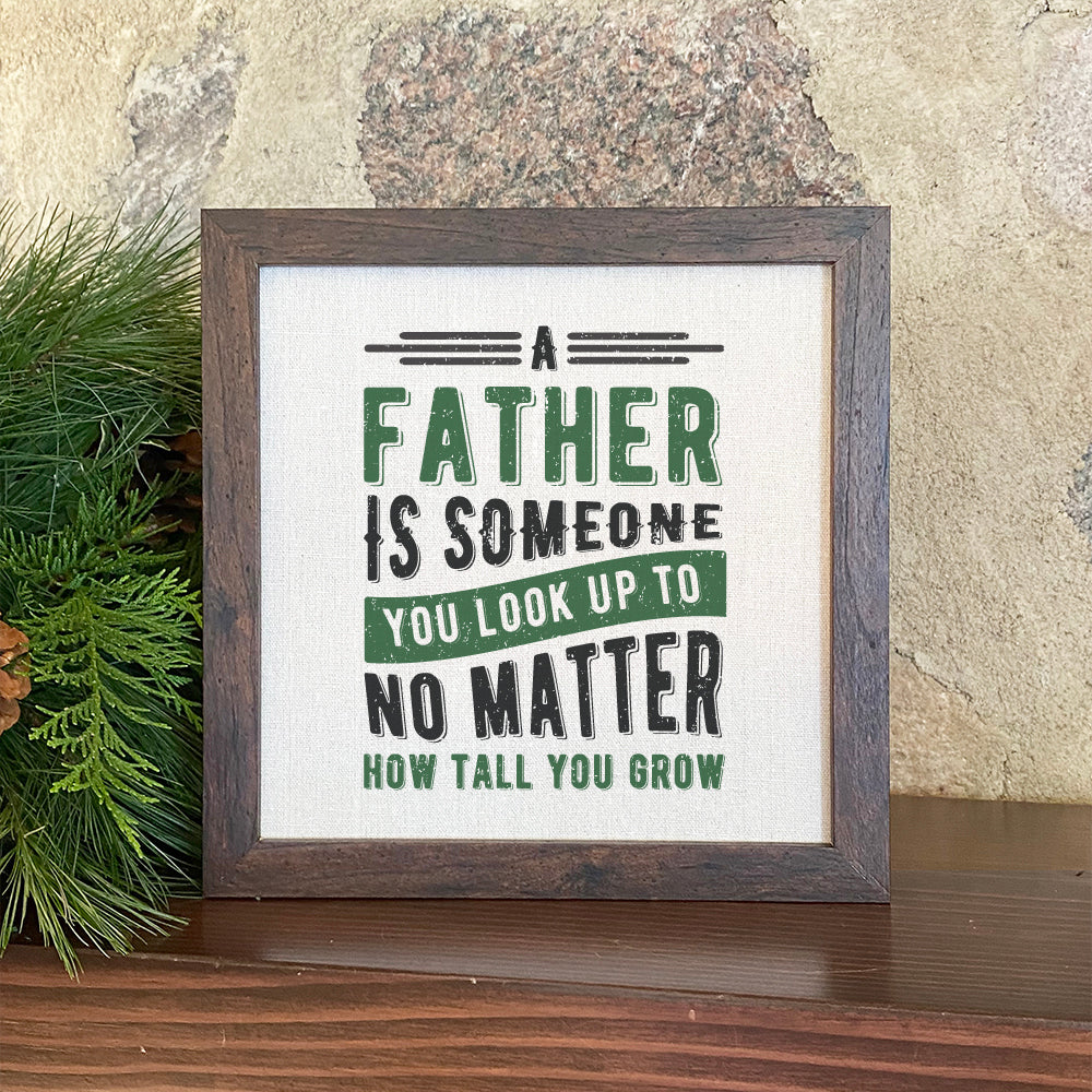 Framed sign with 'Father Look Up To' text, stylish wood frame, eco-friendly ink on linen-look background.