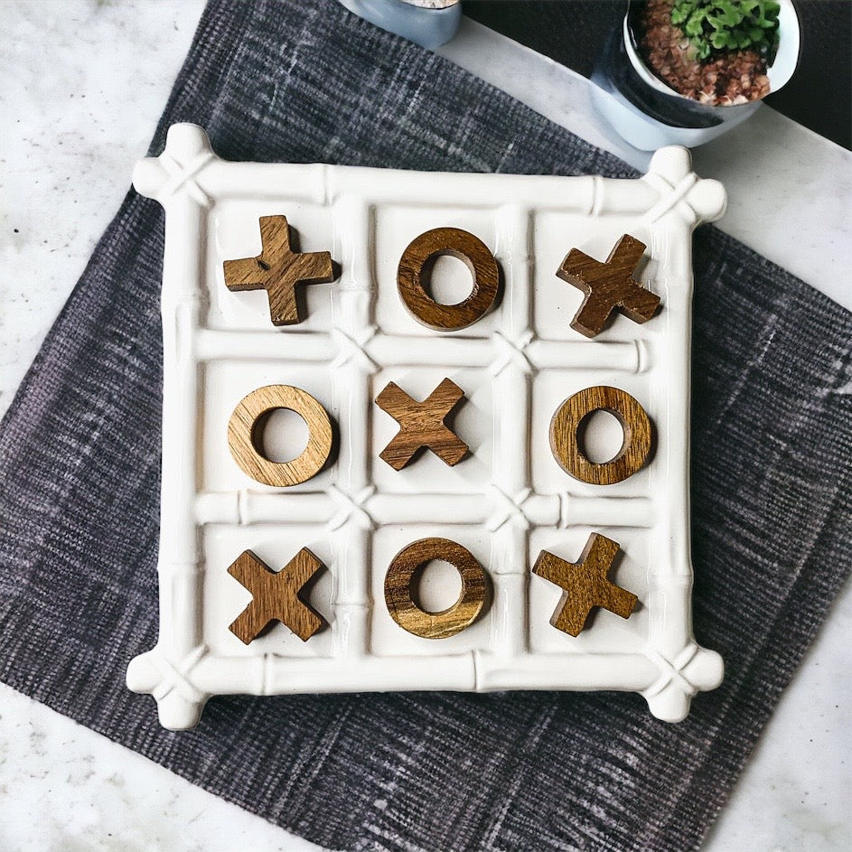 Faux Bamboo Tic Tac Toe game featuring a ceramic board and acacia wood pieces, elegantly designed for decor and play.