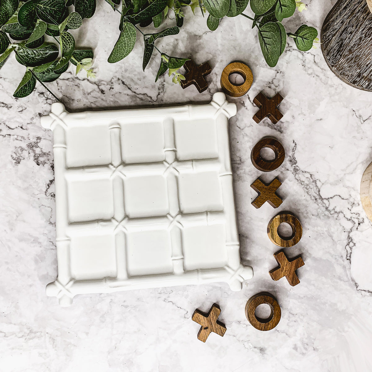 Faux Bamboo Tic Tac Toe game featuring a ceramic board and acacia wood pieces, elegantly designed for decor and play.