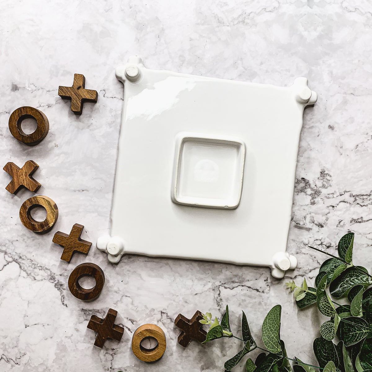 Faux Bamboo Tic Tac Toe game featuring a ceramic board and acacia wood pieces, elegantly designed for decor and play.