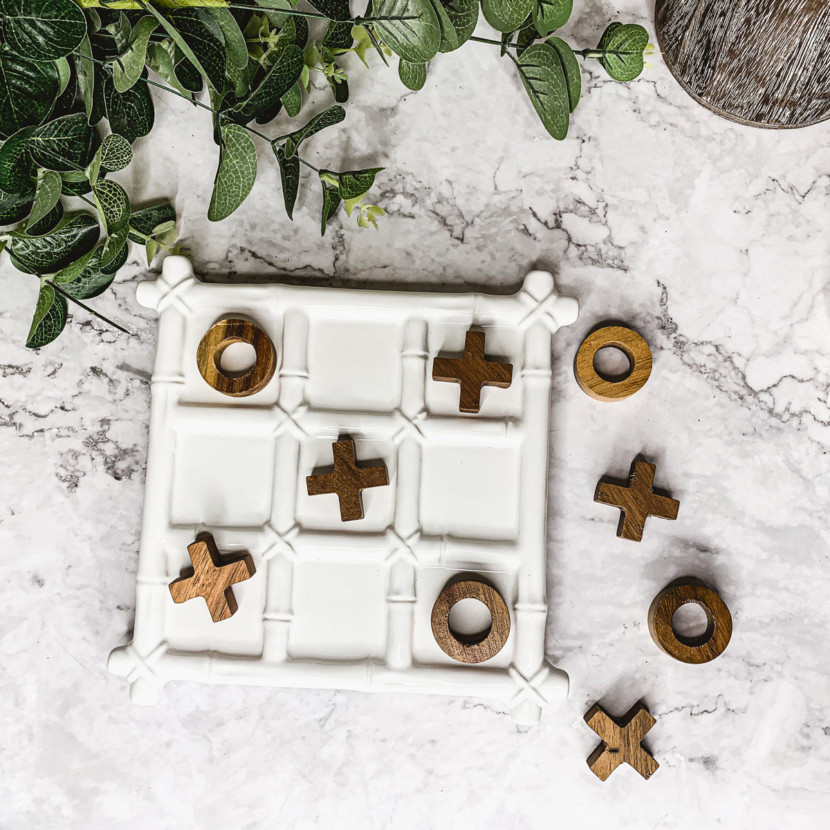 Faux Bamboo Tic Tac Toe game featuring a ceramic board and acacia wood pieces, elegantly designed for decor and play.